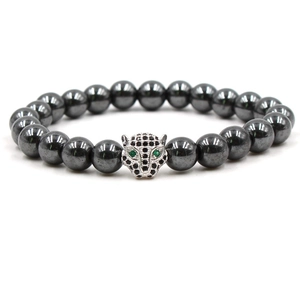 Detail shot of black beaded bracelet featuring a silver leopard head with green eyes