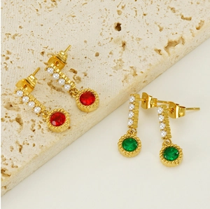 Detailed close-up of vintage gold earrings with green and red faceted oval gemstones