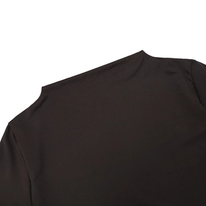 Detail of the black long sleeve dress featuring an asymmetric off-shoulder neckline design