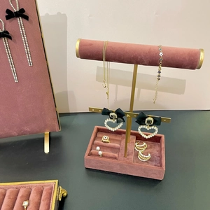 Elegant pearl jewelry set displayed on a premium pink velvet organizer stand