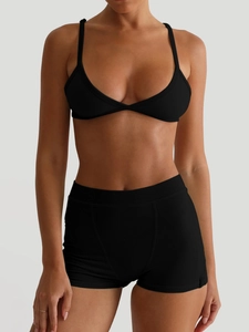 Women's black Y2K style camisole bra and yoga shorts set shown on a model