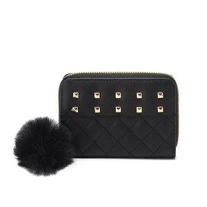 Black small wallet for women featuring gold studs, quilted pattern and fur pompom charm