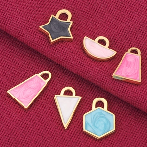 Gold-plated stainless steel lock charms with colorful enamel filling on red fabric