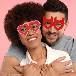 Couples wearing heart-shaped glitter glasses and devil horn frames for party photo props