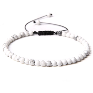 Close-up of 4mm white howlite stone beads with black adjustable braided nylon cord bracelet
