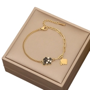 Evil eye gold chain bracelet with elephant charms on a luxury jewelry display box