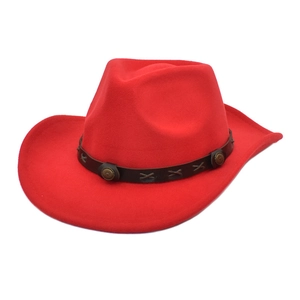 Detail of red wool cowboy hat with brown leather band and metallic rivets decoration