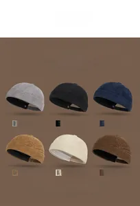 Detail of corduroy docker caps in six retro colors with clear ribbed texture and adjustable buckle