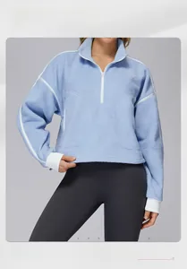 Detail of light blue sherpa fleece sweatshirt with white zipper and stripe accents