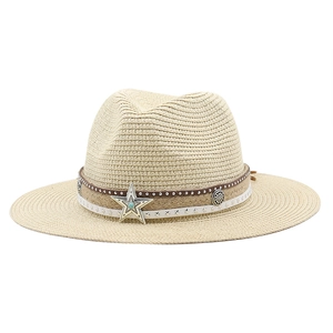 Detail of bohemian straw hat featuring a turquoise star ornament and leather band