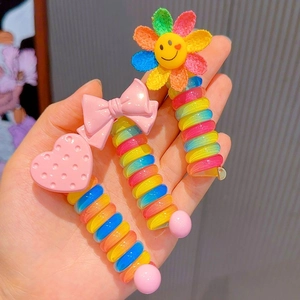 Cute rainbow spiral telephone wire hair ties for kids with heart, bow, and flower charms