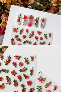 Pegatinas 3D para uñas con rosas rojas vintage y hojas verdes sobre un fondo blanco puro
