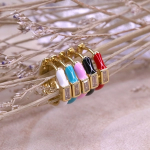 Close-up of candy-colored enamel hoop earrings with inlaid rectangular zircons