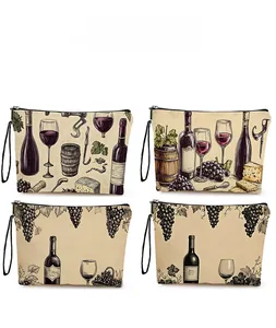 Detail view of four canvas makeup bags with vintage red wine and vineyard illustrations