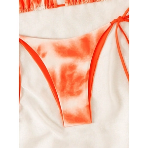 Detail of orange and white tie-dye bikini bottom with side tie straps on white background