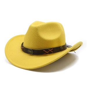 Detail of yellow felt cowboy hat with leather band, steer head buckle and fringe