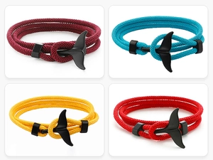 Detail of whale tail nautical bracelets in burgundy, sky blue, golden, and red cord