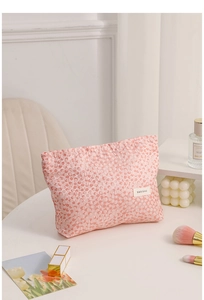 Detailed view of pink bubble texture fabric on a large portable cosmetic storage bag