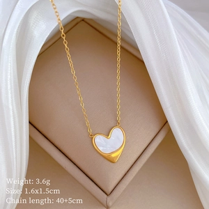 Detail of heart shell pendant with gold plating on jewelry box showing 1.6x1.5cm size