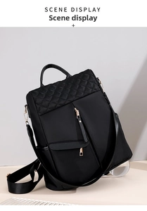Close-up of black nylon backpack featuring quilted diamond pattern and gold hardware details
