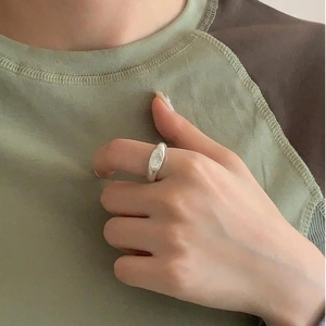 Detailed view of an irregular 925 silver star ring on a model with polished finish