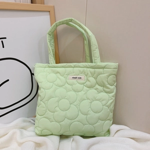 Quilted light green tote bag with floral stitching and Simple Wish label on fabric