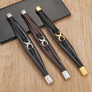 Detailed view of woven leather bracelets with infinity charms on a wooden surface