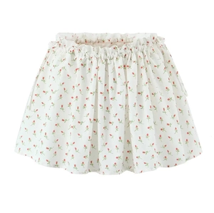 Detail of white floral skirt with elastic ruffled waist and red flower patterns