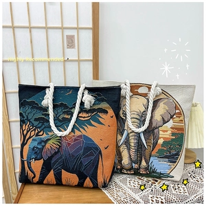 Detail of artistic elephant print tote bags with cotton linen texture and rope handles