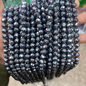 Macro detail of faceted dark grey terahertz beads with a metallic iridescent coating