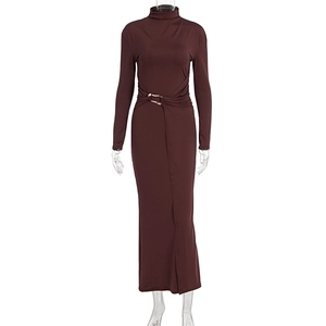 Detail of the elegant red-brown slim fit dress with golden metal ring and waist pleats