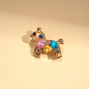 Detailed macro view of rocking horse brooch featuring colorful rhinestones on gold alloy
