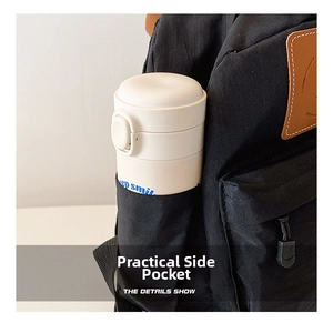 Close-up of side pocket on black canvas backpack showing storage for a water bottle