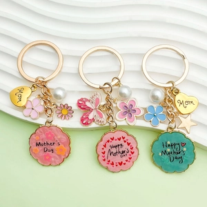 Detail of colorful enamel Mother's Day keychains with pearl charms and gold accents
