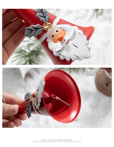 Detail of red Christmas iron bell featuring Santa Claus motif and internal clapper view