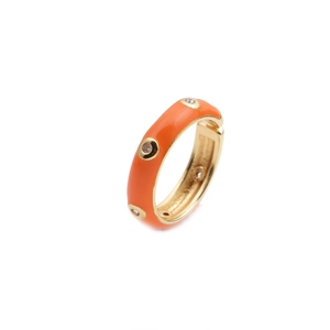 Modern orange enamel ring with inlaid crystals and gold-plated finish on white background