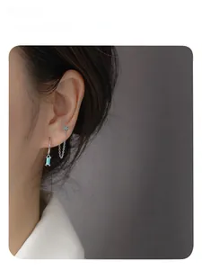 Detail shot of silver butterfly earring set with blue turquoise and delicate chains