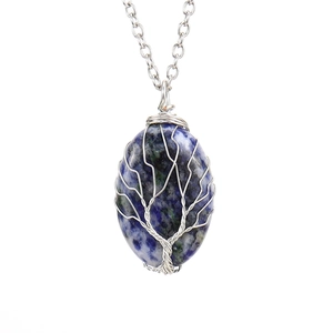 Close-up of tree of life wire wrapped pendant with oval blue natural stone on silver chain