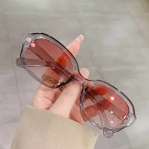 Oval transparent gray sunglasses with stylish red pink gradient lenses for women