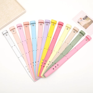 Close-up of DIY leather phone wristbands in 13 colors with metal studs and buckle details