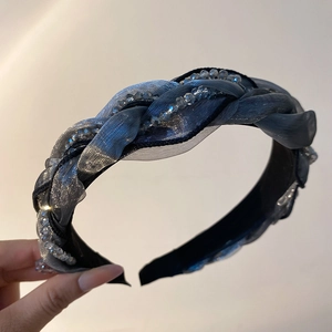 Close-up of blue mesh fabric and faceted crystal beads braided on a non-slip headband