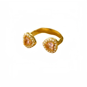 Adjustable gold titanium steel ring with pink heart stones and pearl accents