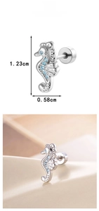 Macro detail of blue zircon seahorse cartilage stud earring showing 1.23cm height dimension