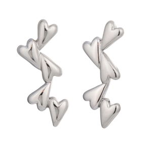 Detail of interlocking silver heart-shaped stud earrings in polished stainless steel