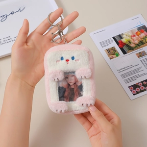 Close-up of pink plush animal card holder showing photo slot and metal keychain attachment