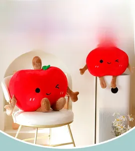 Close-up of cute cartoon red apple plush pillows with soft limbs and embroidered faces