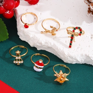Detail of 6-piece Christmas ring set with enamel Santa and reindeer on white stone