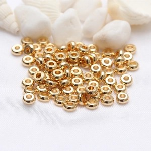 Macro shot of 14k gold-plated spacer beads with glossy finish for DIY jewelry