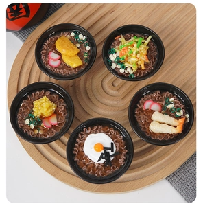 Macro detail of five miniature ramen bowls with realistic eggs and tempura toppings