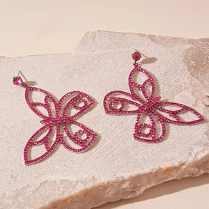 Detail of pink crystal butterfly earrings with sparkling cubic zirconia on stone base